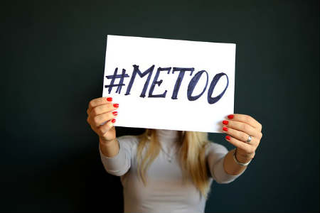 A woman holds "me too" sign