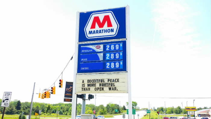 Marathon sign with message on the marquee: "A deceitful peace is more hurtful than open war."