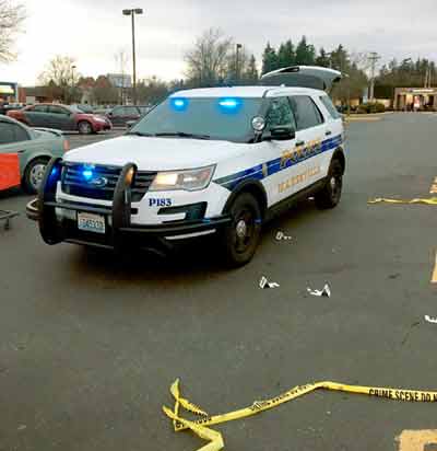 police car with police tape and evidence markers