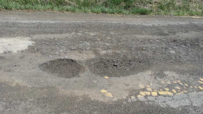 Crumbling roads and potholes