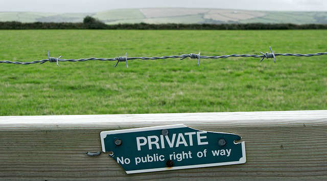 private property sign with barbed wire fence